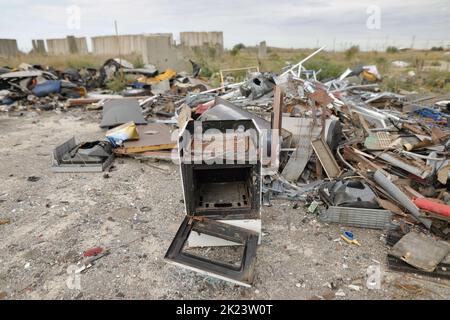 Destroyed oven in a scrap yard. Stock Photo
