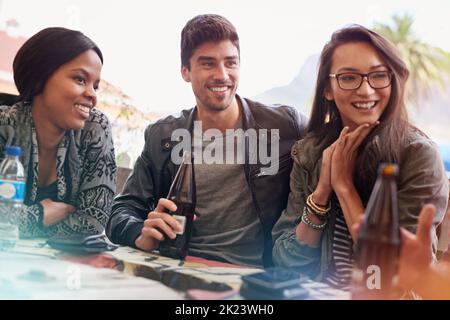 Friends always ready to listen. a group of friends drinking outdoors. Stock Photo