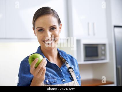 Ill turn this into something amazing. A young woman holding an apple. Stock Photo