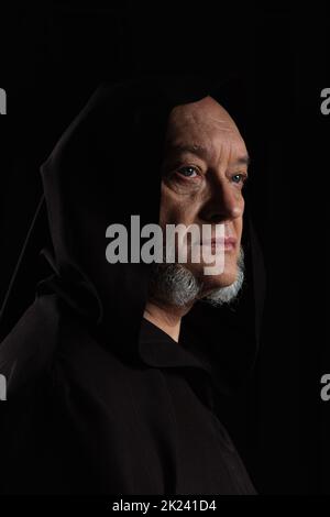 portrait of medieval monk in hooded robe isolated on black,stock image Stock Photo