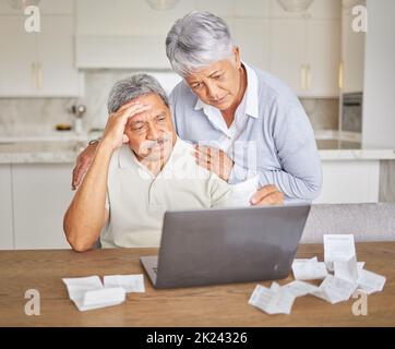 Stress, senior couple and laptop with finance paper and taxes for financial security investment. Sad, depression or mental health anxiety while Stock Photo