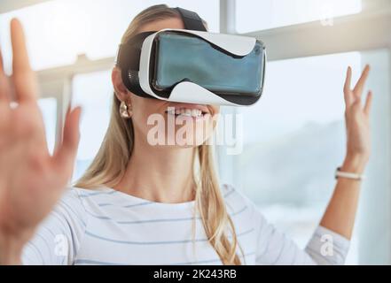 Virtual reality, metaverse and happy woman relaxing and playing vr goggles interactive game using futuristic technology at home. Future, iot and Stock Photo