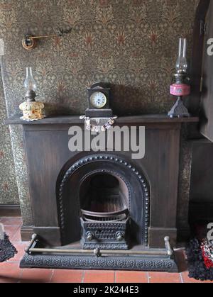 Victorian living room, with furniture, coal fire place, oil lamps, gaslight , wallpaper, Cheshire, England, UK Stock Photo