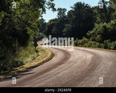 Walking down River Road near Whitehall, Wisconsin in early morning as it winds through the forest near the Trempealeau River. Stock Photo