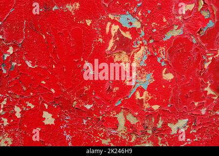 Colorful wall background with damaged paints of red. Stock Photo