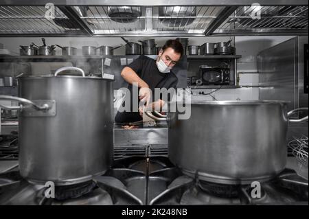Chef cooking in modern industrial kitchen. High quality photo Stock Photo