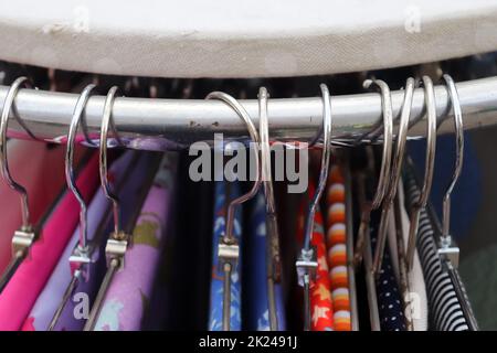 Detailed close up view on samples of cloth and fabrics in different colors found at a fabrics market. Stock Photo