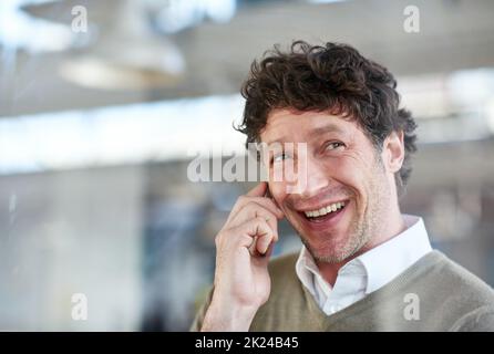 Positive client calls. a casually-dressed businessman talking on his cellphone. Stock Photo