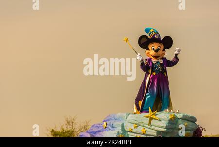 A picture of someone dressed as Mickey Mouse, during a parade, in Disneyland Paris. Stock Photo
