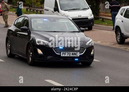 Unmarked police car made by the Ford motor company with its blue lights on and travelling at speed. The numberplate of the vehicle has been digitally altered and does not show the real registration. (132) Stock Photo