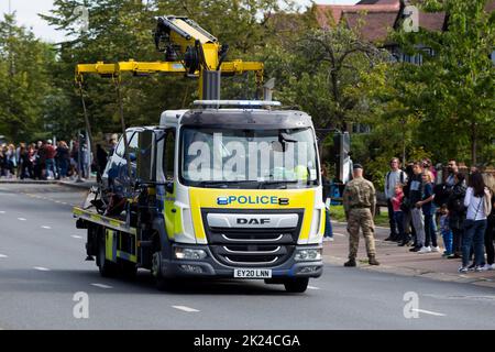 Police tow away vehicle truck removes and illegally parked car at a large event in London. The numberplate of the vehicle has been digitally altered and does not show the real registration. (132) Stock Photo