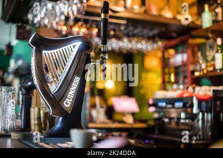 Bucharest, Romania - December 3, 2021: Illustrative editorial image of a Guinness beer tap displayed in a pub in Bucharest, Romania. Stock Photo