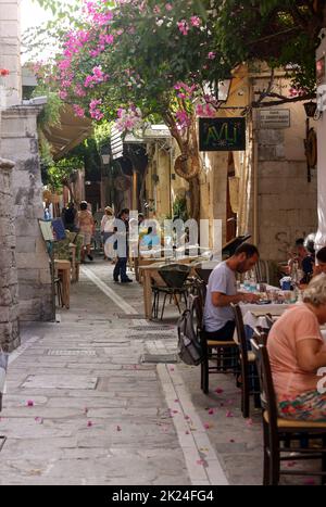 Rethymnon, Crete, Greece - Sept 18, 2021: The narrow street in Old Town of Rethymnon  where there are a lot of small cafes and shops Stock Photo