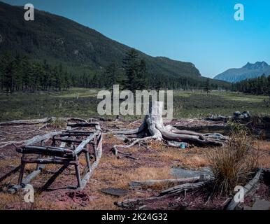 Mountain landscape in Kodar with wooden sleigh and old stump Stock Photo