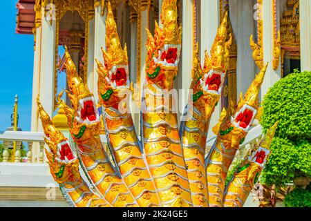 Golden and green dragons dragonfish statues in amazing colorful Wat Don Mueang Phra Arramluang buddhist temple in Bangkok Thailand. Stock Photo