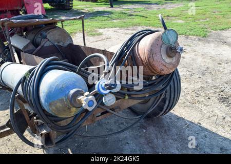 Gas welding equipment. A cylinder with propane and a cylinder with oxygen. Stock Photo