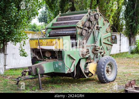 Russia, Temryuk - 15 July 2015: Trailer with a mechanism for creating bales of hay. Stock Photo