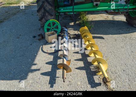 Augers on the floor. Details of the combine. Unloading auger. Stock Photo