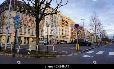 Strasbourg, France - Jul 29, 2017: Tow cars on the almost empty French street in Strasbourg crossing a ridge - clear blue sky Stock Photo