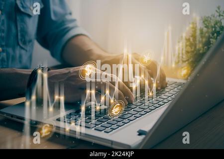 Casual Businessman Hand Using and Typing Laptop Computer with Slant Currency Stock Market Bar Chart and Line Graph Trend. Financial Economy and Busine Stock Photo