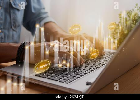Casual Businessman Using and Typing Laptop Computer with Slant Number Value Stock Market Bar Chart and Line Graph Trend. Financial Economy and Busines Stock Photo