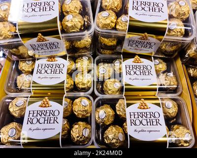 Kiel, Germany - 15. February 2022:  A stack of Ferrero Rocher brand chocolate candies for sale in a supermarket Stock Photo