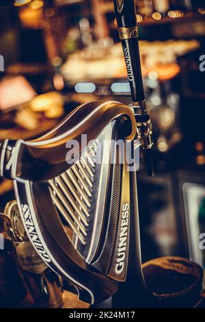 Bucharest, Romania - December 3, 2021: Illustrative editorial image of a Guinness beer tap displayed in a pub in Bucharest, Romania. Stock Photo