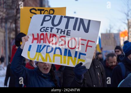 Helsinki, Finland - February 26, 2022: Demonstrator in a rally against Russia’s military aggression and occupation of Ukraine carrying Putin get the h Stock Photo