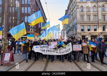 Helsinki, Finland - February 26, 2022: Demonstrators in a rally against Russia’s military aggression and occupation of Ukraine carrying Support Ukrain Stock Photo