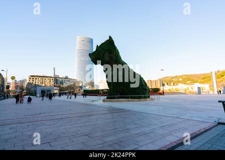 BILBAO, SPAIN-DECEMBER 18, 2021 : Puppy stands guard at Guggenheim Museum in Bilbao, Biscay, Basque Country, Spain. Landmarks. Dog sculpture of artist Stock Photo