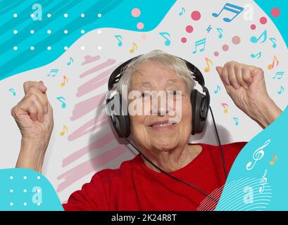 Funny old woman in headphones listening to music Stock Photo