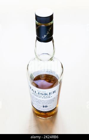 Moscow, Russia - March 20, 2022: bottle of 10 years old Talisker island single malt Scotch whisky on pale table. Talisker 10 year old whisky has been Stock Photo