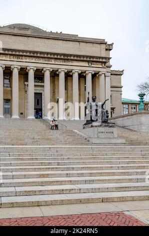 The Library of Columbia University with Students walking on staircase in front of the Building, Black Alma Mater Statue Monument in the forefront, New Stock Photo