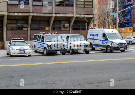 NYPD Different New York Police Department cars and trucks and van parked next to each other at a police station in Harlem next to the street, New York Stock Photo