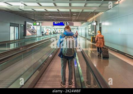 Moving walkway with a man at an airport Stock Photo