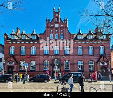 Neumuenster, Germany - 16. April 2022: The historical building of the old post office with a ReWe supermarket in Neumuenster, Germany Stock Photo