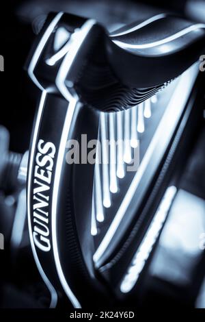 Bucharest, Romania - December 3, 2021: Illustrative editorial image of a Guinness beer tap displayed in a pub in Bucharest, Romania. Stock Photo