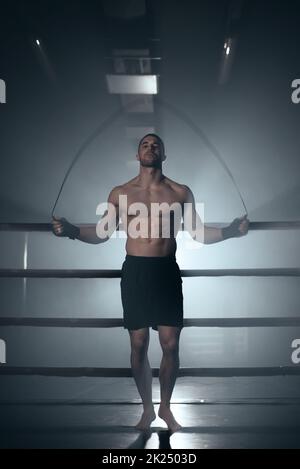 Boxer jumping rope in boxing ring. High quality photo Stock Photo