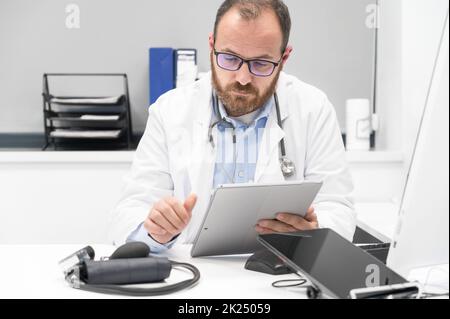 Doctor using his tablet computer at work. High quality photo Stock Photo