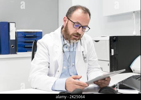 Doctor using his tablet computer at work. High quality photo Stock Photo