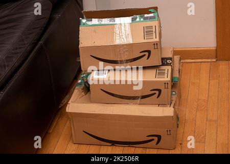 London, United Kingdom - January 31, 2022: Pile of delivered closed cardboard packages from Amazon Prime service and other sellers after parcel has be Stock Photo