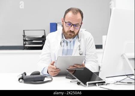 Doctor using his tablet computer at work. High quality photo Stock Photo