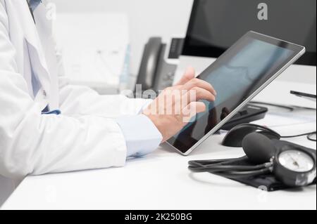 Doctor using his tablet computer at work. High quality photo Stock Photo