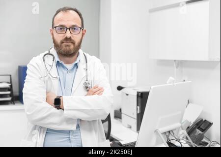 Portrait of confident doctor crossing hands and smiling at camera. High quality photography. Stock Photo