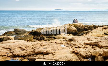 Acadia National Park, ME, October 5, 2020: Elderly couple enjoying a beautiful day on the Atlantic coast of Acadia National Park Stock Photo