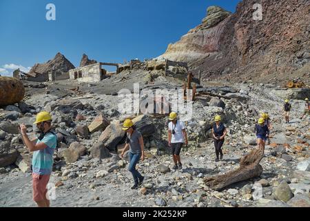 White Island, New Zealand - Circa 2016: White Island Volcanic landscape, tourist group walking in gas masks to see the crater on an organized volcano Stock Photo