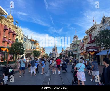 Bay lake, FL USA - September 14, 2022: Roadside view of tourists walking down the main street USA at the magic kingdom park with fall design Stock Photo