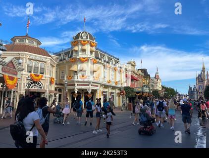 Bay lake, FL USA - September 14, 2022: Roadside view of tourists walking down the main street USA at the magic kingdom park with fall design Stock Photo