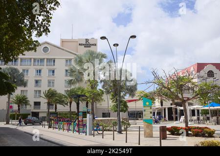 ORANJESTAD, ARUBA - DECEMBER 4, 2021: Plaza Daniel Leo square with Renaissance Resort Hotel, Renaissance Mall and Green Bike rental station in the cit Stock Photo