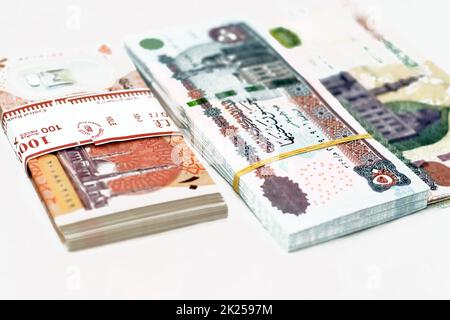 selective focus of stack of new Egyptian money banknotes currency of different values with rubber bands isolated on white background, pile of new poly Stock Photo